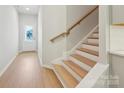 Bright entryway with light wood floors, white walls, and a staircase leading to the upper level of the house at 113 Alluvium Ln, Waxhaw, NC 28173