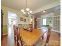 Traditional dining room featuring a wooden table, chandelier, and hardwood floors at 139 Tenth Green Ct, Statesville, NC 28625