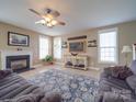 Inviting living room with a cozy fireplace, neutral tones, and ample natural light at 139 Tenth Green Ct, Statesville, NC 28625