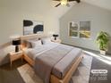 Vaulted main bedroom with large window, a ceiling fan, and neutral decor for a bright and airy feel at 14106 Carriage Lake Dr, Charlotte, NC 28273