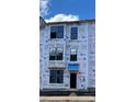 View of new construction townhome with Barricade wrap and black trimmed windows at 15332 Ballancroft Pkwy # 17, Charlotte, NC 28277