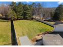 Large fenced backyard with lush green grass and a patio area, perfect for outdoor activities and relaxation at 159 Creekwood Dr, Mooresville, NC 28117