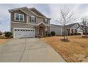 Beautifully designed home with a well-maintained lawn and a spacious driveway at 173 Glastonbury Dr, Mooresville, NC 28115