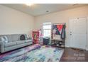 Cozy room with a comfy couch, a bright window, and a practical storage area for everyday necessities at 173 Glastonbury Dr, Mooresville, NC 28115