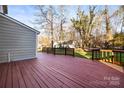Large back deck offering outdoor living and a view of the expansive yard and detached garage at 1919 Windlock Dr, Charlotte, NC 28270