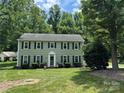 Inviting two-story home features classic architecture, lush landscaping, and a welcoming entrance at 1919 Windlock Dr, Charlotte, NC 28270