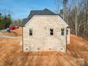 Rear elevation of a new home construction highlighting the brick exterior and window placement at 236 Mark Ryan Ln, Dallas, NC 28034