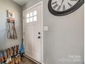 Bright entryway with a white front door, a decorative clock, and a practical shoe rack at 307 Walnut St, Clover, SC 29710