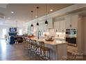 Open kitchen boasts a large island with seating, pendant lighting, stainless steel appliances and ample cabinet space at 3089 Founding Fathers Dr # 43, Gastonia, NC 28056