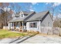 Well-maintained home with a covered front porch and gravel driveway near a wooden fence at 400 Joe Cloninger Rd, Bessemer City, NC 28016