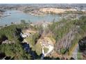 Beautiful aerial view of the lakeside house, showing the trees surrounding the property at 4616 Gold Finch Dr, Denver, NC 28037