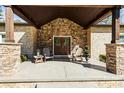 Charming front porch with stone columns and double doors, creating a warm and welcoming entrance at 4616 Gold Finch Dr, Denver, NC 28037