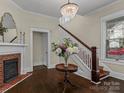 Elegant foyer with hardwood floors, staircase, fireplace, and decorative chandelier at 629 S Fulton St, Salisbury, NC 28144