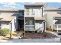 Two-story condo featuring a balcony, sidewalk, and minimal landscaping at 100 Willow Run Dr # 7, Gastonia, NC 28056