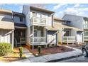 Two-story condo featuring a balcony, sidewalk, and minimal landscaping at 100 Willow Run Dr # 7, Gastonia, NC 28056