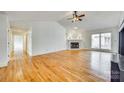 Bright living room with hardwood floors, fireplace, and ample natural light at 10033 Bora Bora Dv, Tega Cay, SC 29708