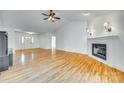 Open-concept living room featuring hardwood floors, a fireplace, and easy access to the entryway at 10033 Bora Bora Dv, Tega Cay, SC 29708