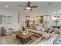 Bright, open-concept living room flows into modern kitchen featuring stainless appliances and a large central island at 1049 Kinship Dr # 77, Lancaster, SC 29720