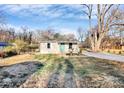 An inviting bungalow with a covered front porch and a walkway leads up to the front of the home at 1061 Gaither Nw Pl, Concord, NC 28027