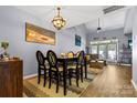 Elegant dining room with stylish light fixture and seamless flow to living area at 11141 Lions Mane St, Charlotte, NC 28273