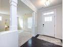 Inviting foyer features dark wood floors, white walls, and a stylish front door, creating a welcoming entrance at 11440 Westbranch Pkwy, Davidson, NC 28036