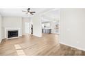 Bright living room featuring a fireplace, ceiling fan, and seamless flow into the kitchen at 120 Roger Dr, Statesville, NC 28625
