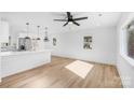 Bright and airy living room with hardwood floors and stylish pendant lighting over the kitchen island at 1324 Southampton St, Shelby, NC 28152