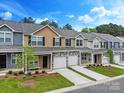 Charming townhomes with well-manicured lawns, individual driveways, attached garages, and diverse color schemes at 13529 Browhill Ln, Charlotte, NC 28278