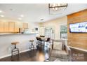 Inviting living area featuring dark wood floors, an open layout to the kitchen, and a cozy armchair at 13529 Browhill Ln, Charlotte, NC 28278