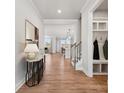 Inviting entryway with wood flooring, coat rack, and view of the kitchen and Gathering room at 2006 Mantle Ridge Dr, Indian Trail, NC 28079