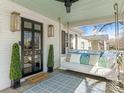 Inviting front porch with a swing, stylish decor, and a 'Welcome' mat, perfect for relaxing outdoors at 2028 Scott Ave, Charlotte, NC 28203