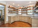 Stylish kitchen with custom shelving, granite countertops, and stainless steel appliances at 2112 Floral Ave, Charlotte, NC 28203