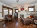 Inviting living room featuring a cozy fireplace, hardwood floors, and ample natural light at 2112 Floral Ave, Charlotte, NC 28203