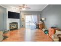 Bright living room featuring a cozy fireplace, hardwood floors, and sliding glass doors to a deck at 2864 Sweeping Pine Ln, Denver, NC 28037