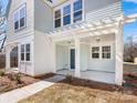 Inviting front porch with white columns, modern lighting, and a stylish front door at 3215 Isenhour St, Charlotte, NC 28206