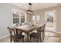 Elegant dining room featuring a stylish table set, modern lighting, and ample space for gatherings at 417 Columbus Ln, Monroe, NC 28110