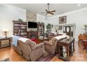 Inviting living room with a stone fireplace, built-in bookshelves, and comfortable seating for relaxing and entertaining at 4321 Rolling Acres Rd, Charlotte, NC 28213