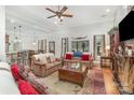 Bright, open living room featuring wood floors, a beamed ceiling, and lots of natural light at 4321 Rolling Acres Rd, Charlotte, NC 28213