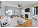 Bright living room with fireplace, hardwood floors, and a modern design scheme at 5000 Tulip Ln, Matthews, NC 28104