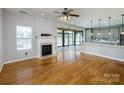 Living room with a fireplace and access to a sunroom and kitchen through sliding doors at 5000 Tulip Ln, Matthews, NC 28104