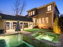Luxurious backyard oasis with a sparkling pool, spa, covered patio, and putting green at 519 Fourth Baxter Xing, Fort Mill, SC 29708