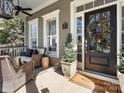 Inviting front porch with comfortable seating, potted plants, and a welcoming entrance at 519 Fourth Baxter Xing, Fort Mill, SC 29708