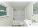 Bright bathroom with a tub-shower combination and ample natural light from the window at 609 Cedar St, Wadesboro, NC 28170