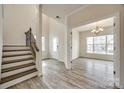 Welcoming foyer with wood-look flooring, stairs and view to the dining room at 844 Braddock Way, Fort Mill, SC 29715