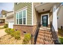 Inviting front entrance featuring brick steps, a stylish door, and manicured landscaping at 844 Braddock Way, Fort Mill, SC 29715