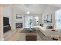 Bright living room featuring a fireplace, neutral decor, vaulted ceilings, and abundant natural light at 1012 Equipoise Dr, Indian Trail, NC 28079