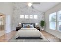 Main bedroom with a large window, a ceiling fan and ensuite bathroom with lots of natural light at 1012 Equipoise Dr, Indian Trail, NC 28079