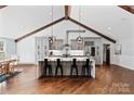 Bright, open kitchen featuring a large island, pendant lighting, stainless steel appliances, and exposed beams at 1131 Doby Ct, Fort Mill, SC 29715