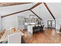Spacious kitchen with a large island, stylish pendant lighting, and a dining area with ample seating at 1131 Doby Ct, Fort Mill, SC 29715