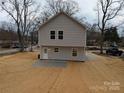 View of the backyard showing the rear facade, the lawn and a new concrete patio at 1302 Browdis Ave, Kannapolis, NC 28083